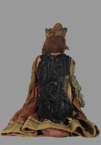 wooden doll with cape